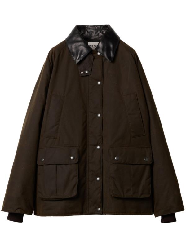 Dark brown Miu Miu waxed canvas blouson jacket hanging on a swinger