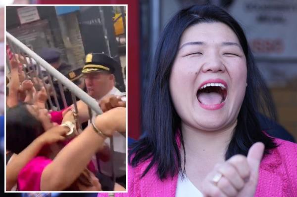 Susan Zhuang laughing while surrounded by a group of suited men