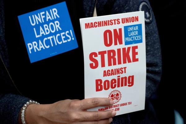 A Boeing worker from the Internatio<em></em>nal Association of Machinists and Aerospace Workers District 751 holds a sign while attending a rally at their unio<em></em>n hall during an o<em></em>ngoing strike in Seattle, Washington, U.S. October 15, 2024. REUTERS/David Ryder
