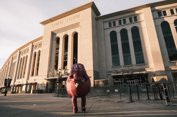 "Grimace" stands outside Yankee Stadium in the Bronx, NY.