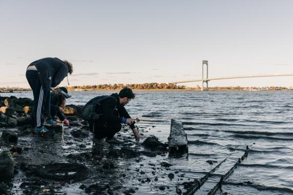 Thay-Ling Moya Perez, right, and a volunteer work wild oyster survey at Powell's Cove Park in Queens