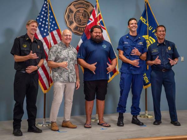 Lifeguard Noland Keaulana joins Hawaii and Coast Guard officials making shaka gestures during a news co<em></em>nference on Oct. 17, 2024.